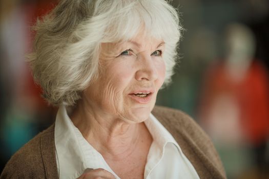 Portrait of nice smilig thoughtful senior woman close up