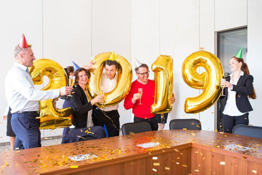 Business people celebrating 2019 New Year at office party