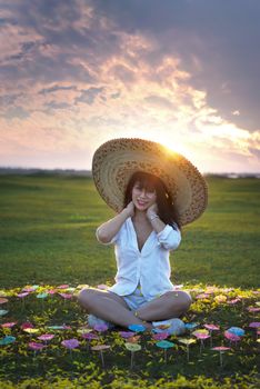 beautiful woman in white dresses and big hat with beautiful nature on sunset times