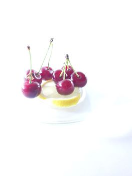 Photo cherry and lemon. Healthy food. Vegetarian red food. Berries and fruits. Berry for snack. 