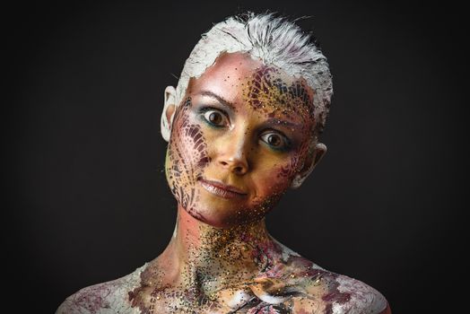 Portrait of Beautiful Young Woman with creative fantasy bird makeup