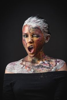 Portrait of Beautiful Young Woman with creative fantasy bird makeup