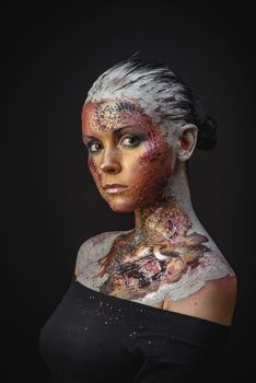 Portrait of Beautiful Young Woman with creative fantasy bird makeup