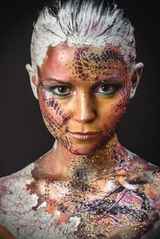 Portrait of Beautiful Young Woman with creative fantasy bird makeup