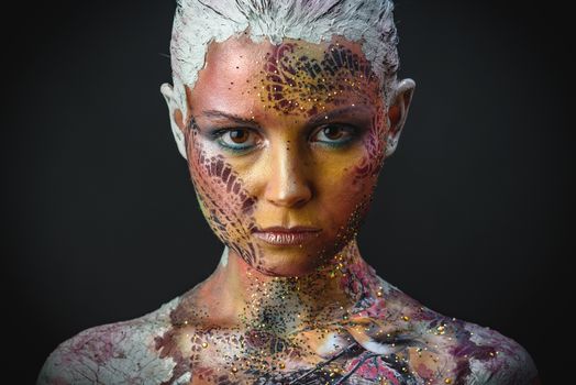 Portrait of Beautiful Young Woman with creative fantasy bird makeup