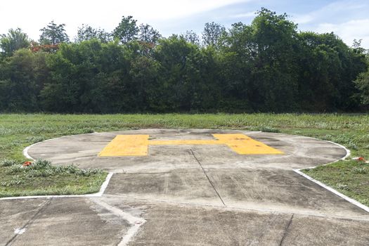 Heliport There are many trees in the background. On a sunny day.