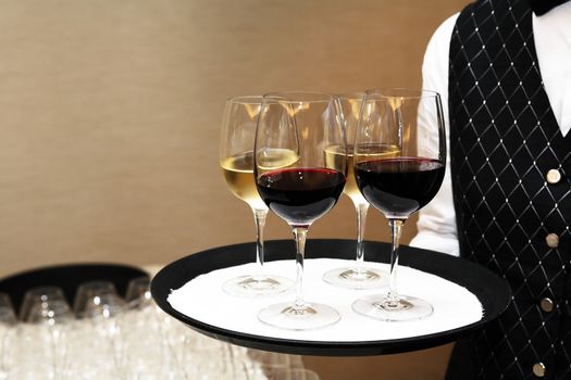 Cocktail party. Waiter holding platter with wineglasses