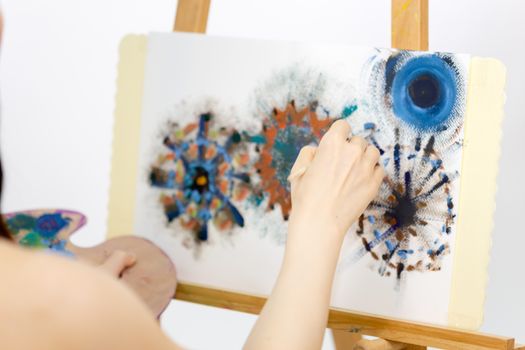 Anonymous artist painting on an easel