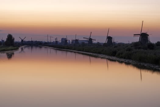 Historic windmills at Kinderdijk, The Netherlands, in beautiful twilight.
