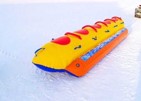 Inflatable rubber multi-seat sleigh for high-speed snow skiing in winter, winter activity concept and Christmas fun.