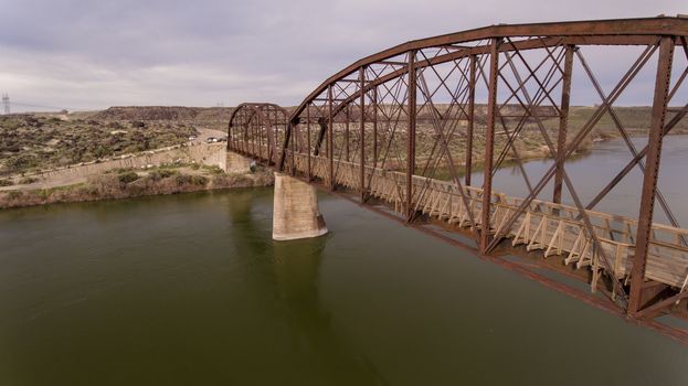 side view of a bridge as it is going over a river