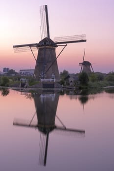 Historic windmills at Kinderdijk, The Netherlands, in beautiful twilight.