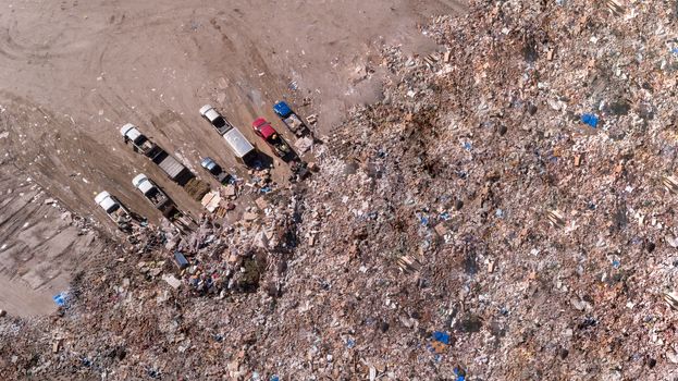 trucks dumping off trash at the local landfill