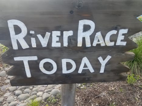 wood river race sign on wood stake with stones or rocks