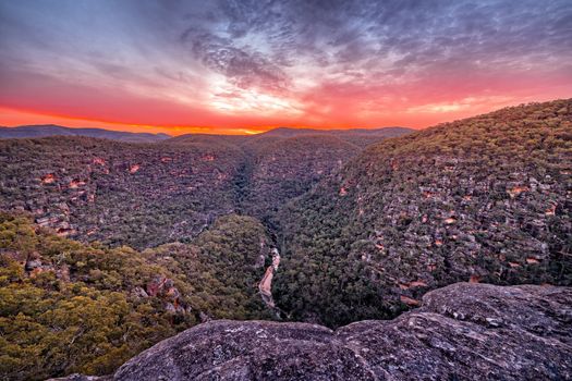 Sunset overlooking the Wollemi National Park Wilderness below a junction of the Colo River and Wollemi creek.  From a steep descent to a rocky outcrop offer uninterrupted views all around. There is also a steep pass that leads down to the bottom