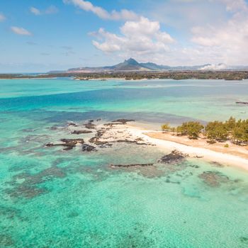 Aerial view of beautiful tropical beach with turquoise sea. Tropical vacation paradise destination of D'eau Douce and Ile aux Cerfs Mauritius