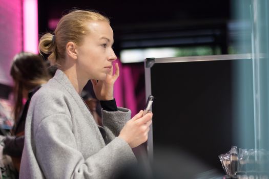 Women buying and testing cosmetics in a beauty store.