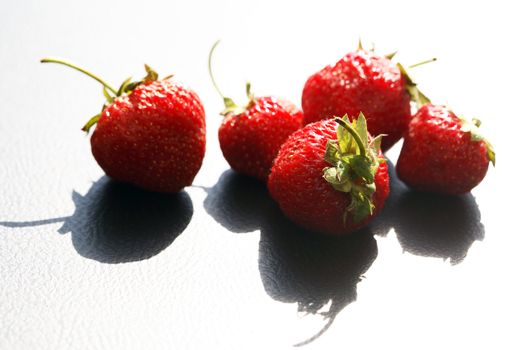 Few strawberry fruits against morning sun light