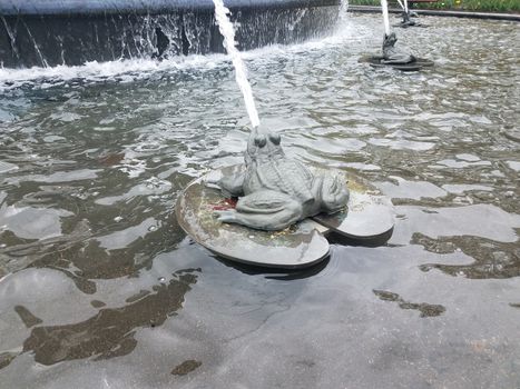 water fountain with frog shooting a stream or jet of water