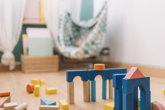 colorful wooden building blocks in the floor at home or kindergarten, educational toys for creative children