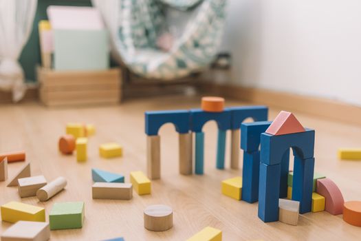 colorful wooden building blocks in the floor at home or kindergarten, educational toys for creative children