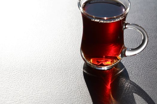 Nice small cup of Turkish black tea against sunlight