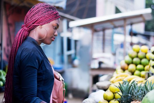 beautiful young woman buying fruit at the  market.
