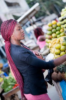 beautiful young woman buying fruit at the  market.