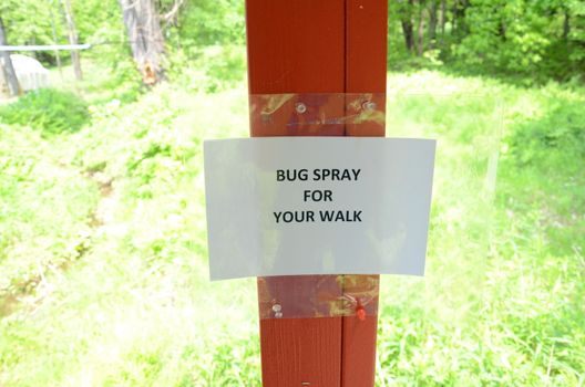 laminated bug spray for your walk sign on wood post