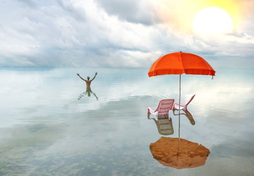Two pink lounge chairs with  sun umbrella in a sea and A very happy man  with outstretched arms