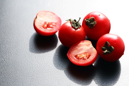 Few red ripe tomatoes against sun light