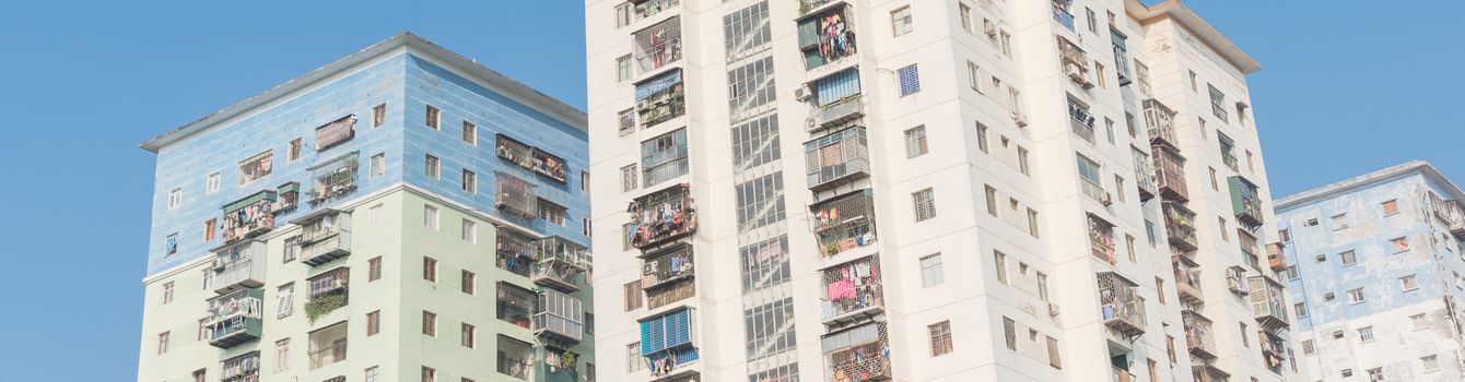 Panorama view typical high-rise apartment complex in Hanoi, Vietnam with hanging clothes over balcony