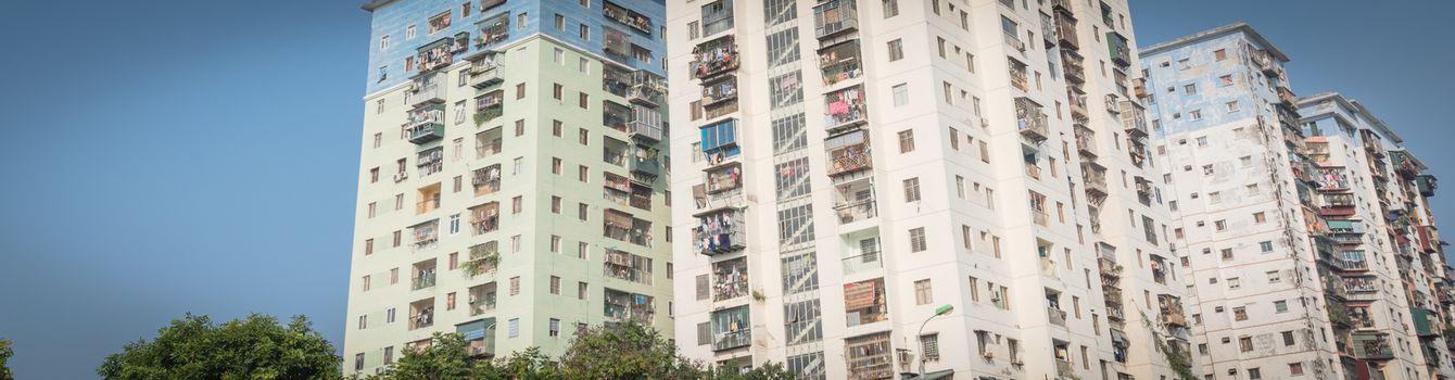 Panorama view typical high-rise apartment complex in Hanoi, Vietnam with hanging clothes over balcony