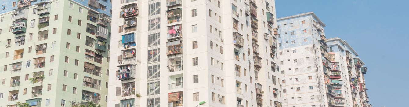 Panorama view typical high-rise apartment complex in Hanoi, Vietnam with hanging clothes over balcony