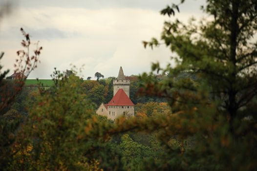 Kokorin Castle in the beautiful autumn forest in Czech Republic