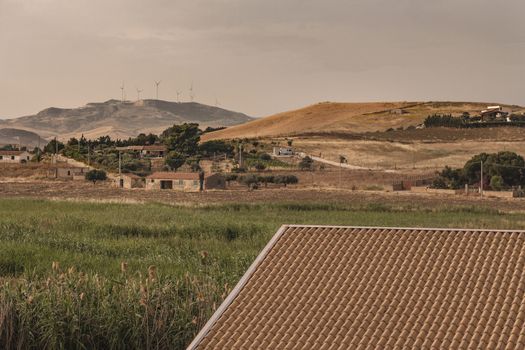 Sicilian Panorama wirh hills, houses and field shoot during summer at sunset