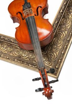 Violin and golden frame on an isolated studio backgound