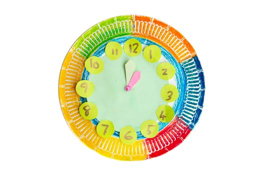 Colorful child handwork clock pointing at 1 o'clock, isolated on white background