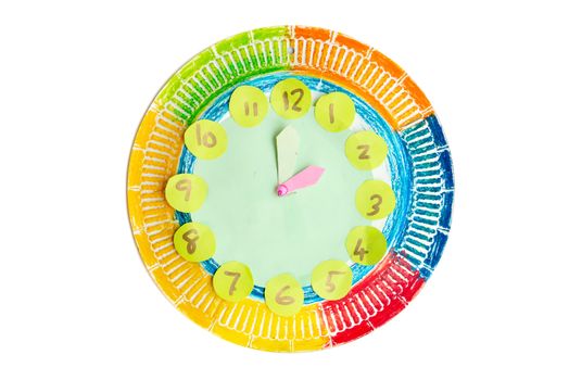 Colorful child handwork clock pointing at 2 o'clock, isolated on white background