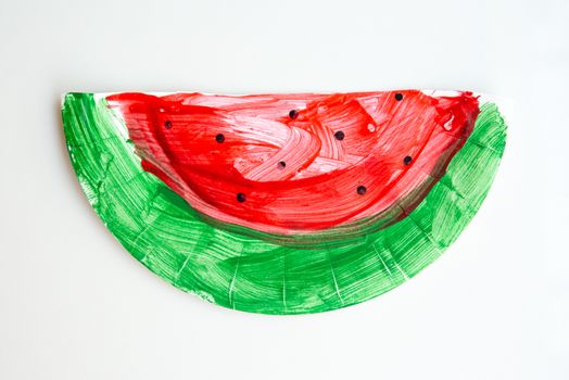 Child artwork, handmade watermelon on plain background.