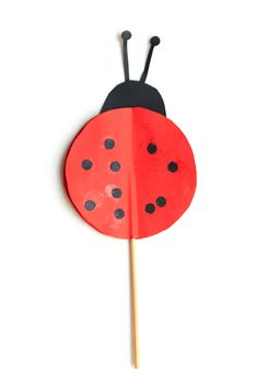 Child artwork, ladybug on plain background.