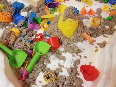 table with sand and plastic tools for kids to play and have fun with