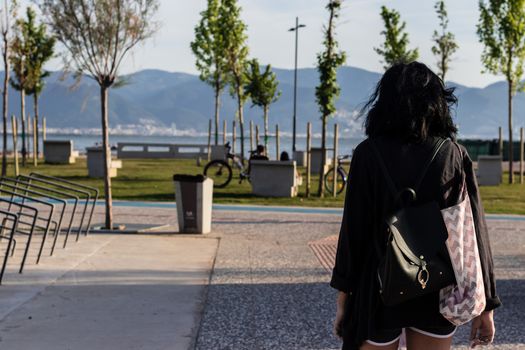 a black haired thin girl looking landscape at afternoon hours. photo has taken at izmir/turkey.