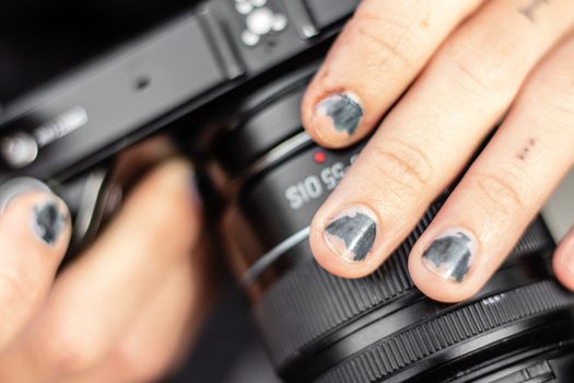 a girl with scratched nail polish holding a camera. photo has taken at izmir/turkey.