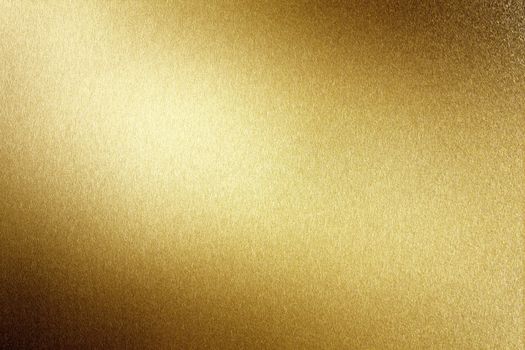 Light shining on brushed gold metal plate, abstract texture background