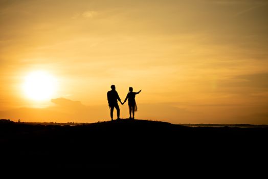 Silhouette traveler couples walking  on mountain at sunset times