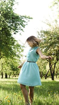 Young woman in sunny garden. Outdoor summer day. Meditation and freedom concept