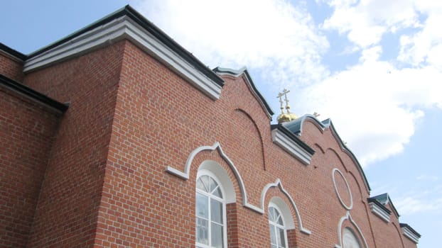 Christian temple in the village of Troekurovo against the blue sky