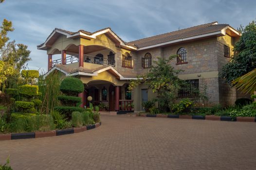 Apartment house with a beautiful entrance porch and a flower bed in the city of Nairobi in Kenya