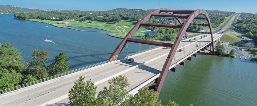 Panorama elevated view of Pennybacker Bridge or 360 Bridge. A landmark in Austin, Texas, USA. Top of Town Lake, Colorado River and Hill Country green landscape